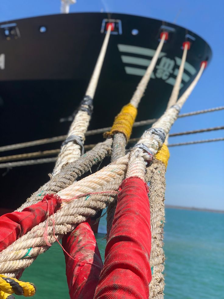 Close-up of heavy mooring ropes securing a vessel alongside